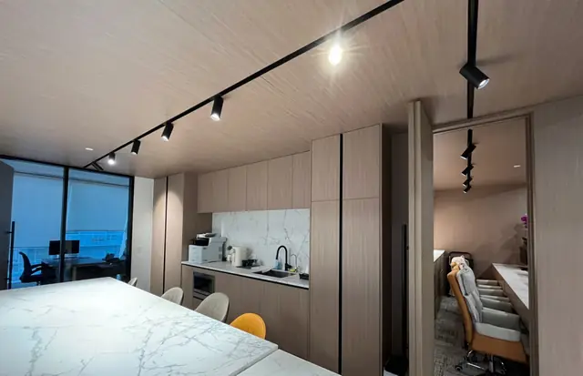Office kitchen and boardroom with custom cabinetry and a marble island