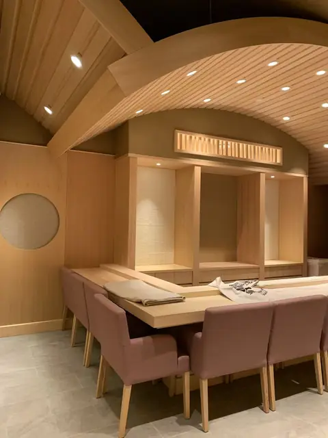 Japanese-inspired dining room with a barrel-vaulted wood slat ceiling