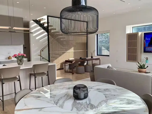 Open-plan kitchen and dining room with modern millwork and staircase screen