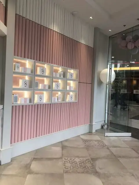 Boutique retail wall with fluted panels and illuminated display niches