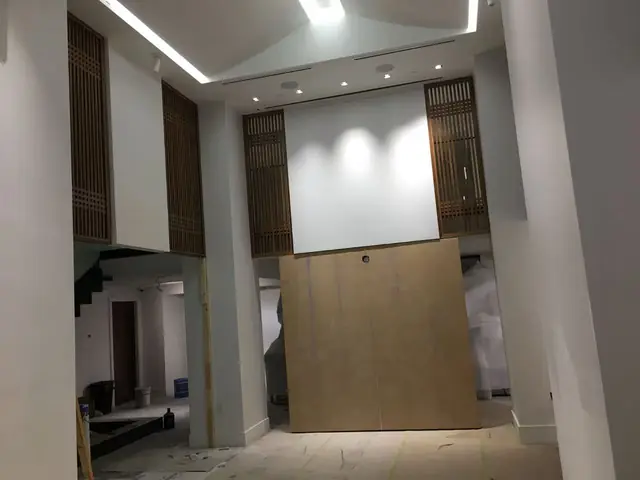 Double-height feature wall with timber screen panels