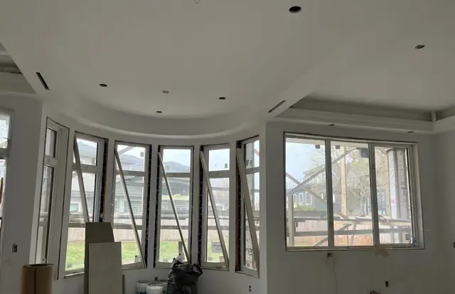 Bay window room with a curved ceiling bulkhead and trim