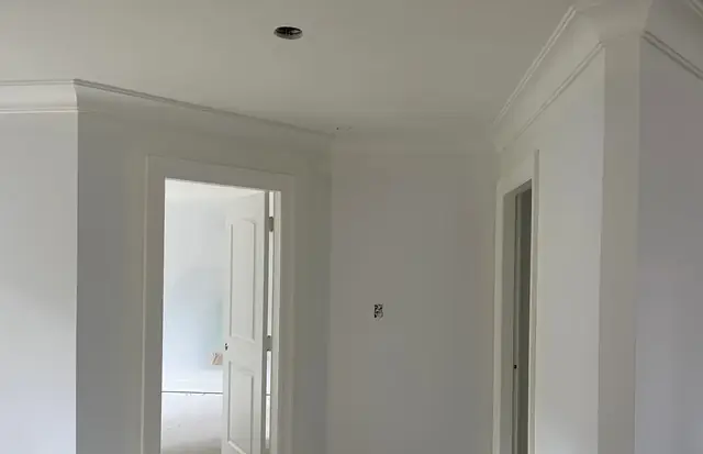 Bedroom with crown moulding, door casing and baseboard