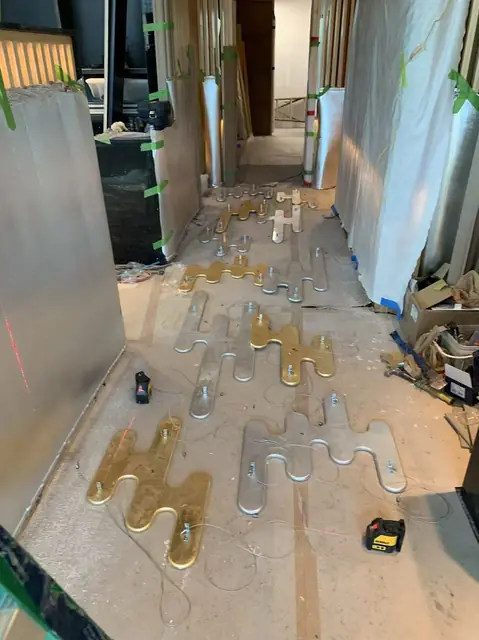 Retail fit-out with wood slat walls and gold ceiling elements in progress