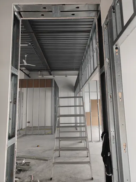 Light-gauge steel stud framing for a mezzanine office